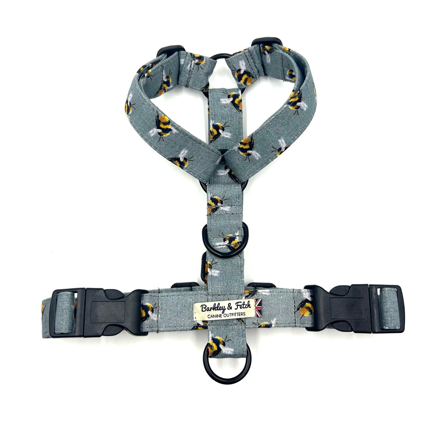 Gray dog harness with black and yellow pattern on a white background