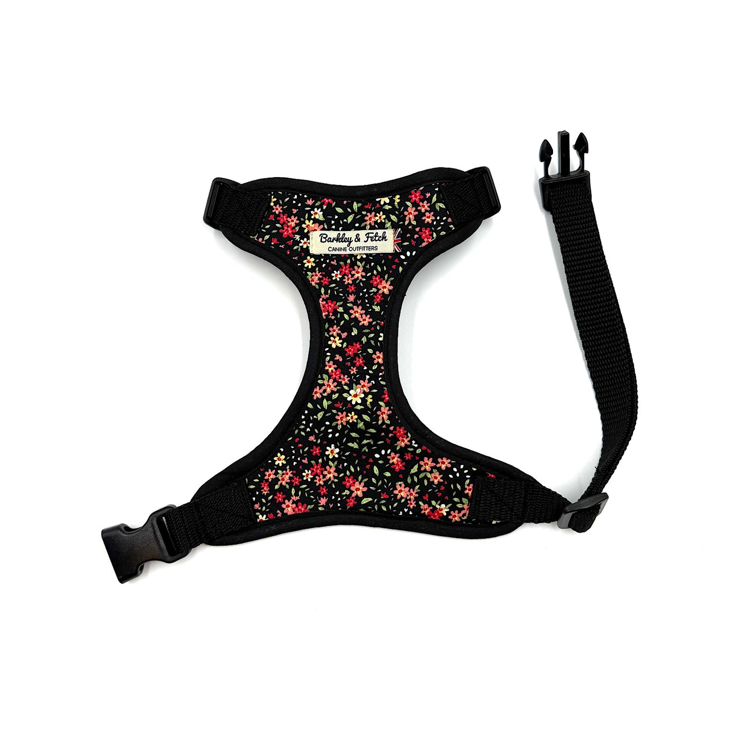 Floral-patterned dog harness with black straps on a white background