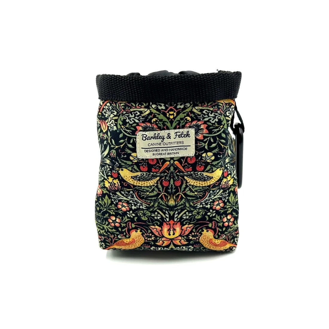 A small canvas pouch with a black top band and a colorful William Morris-style floral and bird pattern on a dark background. A white label reads 'Barkey & Fetch Canine Outfitters'.
