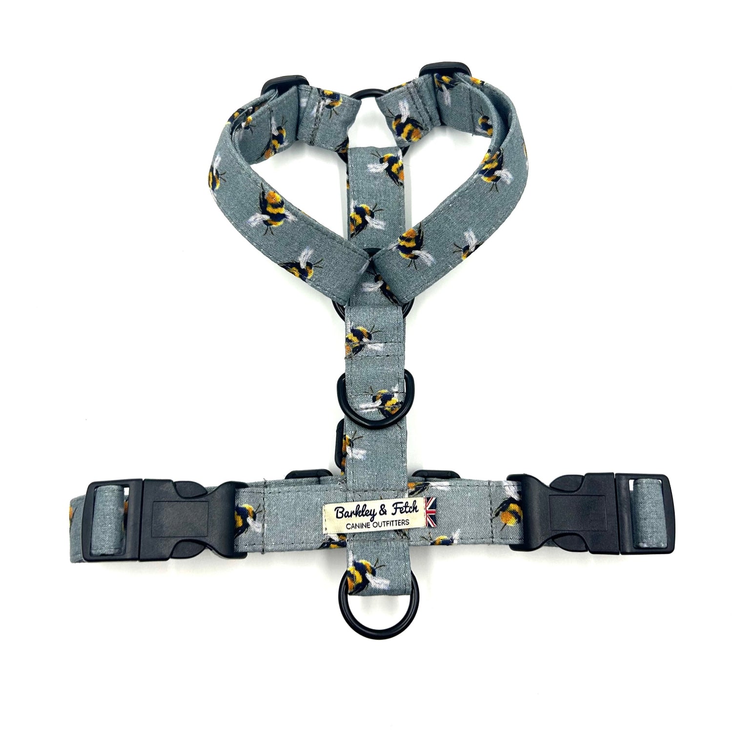 Gray dog harness with black and yellow pattern on a white background