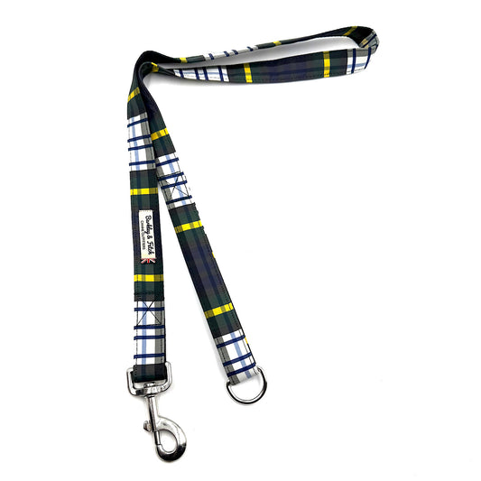 A plaid dog leash with a navy, green, white, and yellow tartan pattern, featuring silver metal hardware on a plain white background.